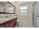 Well-lit bathroom featuring a marble countertop vanity and neutral colored walls and flooring at 10453 W White Mountain Rd, Sun City, AZ 85351