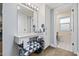 Bright bathroom featuring a vanity area, a large mirror, and a doorway view of the toilet and shower at 10453 W White Mountain Rd, Sun City, AZ 85351