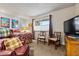 Inviting bedroom with wood furnishings, a comfy reading chair, and relaxing natural lighting at 10453 W White Mountain Rd, Sun City, AZ 85351