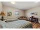 Cozy bedroom featuring two twin beds, a sitting area, and hardwood floors at 10453 W White Mountain Rd, Sun City, AZ 85351