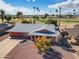 Charming single-story home with a well-manicured front yard and desert landscaping at 10453 W White Mountain Rd, Sun City, AZ 85351