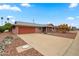 Attractive single-Gathering home featuring a two-car garage and desert landscaping at 10453 W White Mountain Rd, Sun City, AZ 85351