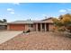 Charming single-story home with a desert-landscaped front yard and a two-car garage at 10453 W White Mountain Rd, Sun City, AZ 85351