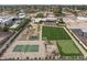 An aerial view displays the expansive backyard with a tennis court, playground, and gardens at 11601 N 85Th St, Scottsdale, AZ 85260