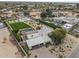 An aerial view shows lush landscaping, a tennis court, and a sparkling pool at this property at 11601 N 85Th St, Scottsdale, AZ 85260