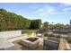 Private outdoor patio featuring a stone firepit, built-in seating, and a sparkling pool at 11601 N 85Th St, Scottsdale, AZ 85260