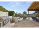 Outdoor patio area featuring a stainless steel BBQ, firepit, and covered seating at 11601 N 85Th St, Scottsdale, AZ 85260