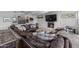 Cozy living room featuring a brick fireplace, large leather couch, decorative pillows, and lots of natural light at 11601 N 85Th St, Scottsdale, AZ 85260