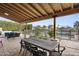 Outdoor patio with wood pergola, outdoor seating and dining area with a view of the pool at 11601 N 85Th St, Scottsdale, AZ 85260