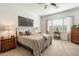 Serene bedroom featuring a comfortable bed, dresser, and a window with natural light at 12519 W Oyer Ln, Peoria, AZ 85383