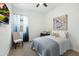 Light-filled bedroom with a comfortable chair, floral curtains, and calm artwork enhances the room's peaceful ambiance at 12519 W Oyer Ln, Peoria, AZ 85383