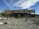 Exterior view of the community clubhouse with desert landscaping, rocks, and native vegetation at 12519 W Oyer Ln, Peoria, AZ 85383