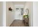 Inviting foyer with a decorative mirror, wooden console table with plants, and stylish decor at 12519 W Oyer Ln, Peoria, AZ 85383