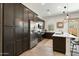 Kitchen with dark cabinets, stainless steel appliances, and white countertops at 12519 W Oyer Ln, Peoria, AZ 85383