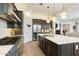 Modern kitchen featuring stainless steel appliances, white counters, and dark cabinetry at 12519 W Oyer Ln, Peoria, AZ 85383