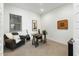 A versatile room features a leather chair, desk setup, and guitar, perfect for a home office or den at 12519 W Oyer Ln, Peoria, AZ 85383