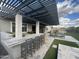 A well-appointed outdoor bar with a pergola, seating, and ample counter space for entertaining at 12519 W Oyer Ln, Peoria, AZ 85383