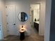 View of a well-lit bathroom with dual sinks and a patterned tile floor from hallway at 13342 W Lariat Ln, Peoria, AZ 85383