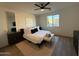 Modern bedroom suite with a bed, decorative wall art, and a ceiling fan at 13342 W Lariat Ln, Peoria, AZ 85383