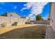 Enjoy this backyard featuring a patio, lawn, and string lights for outdoor entertaining at 13342 W Lariat Ln, Peoria, AZ 85383