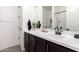 Bathroom with dark cabinets, white countertops, and patterned floors at 13342 W Lariat Ln, Peoria, AZ 85383