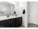 Bathroom featuring a double vanity with black cabinets and gold fixtures at 13342 W Lariat Ln, Peoria, AZ 85383