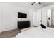 Bedroom featuring a dresser, TV, and a cozy seating area at 13342 W Lariat Ln, Peoria, AZ 85383