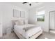 Bedroom with neutral decor, a window, and a throw blanket on the bed at 13342 W Lariat Ln, Peoria, AZ 85383