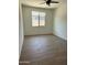 Well lit, simply designed bedroom featuring neutral colors and ceramic tile at 13342 W Lariat Ln, Peoria, AZ 85383