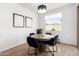 Bright dining room with modern lighting, a round table, and wood-look flooring at 13342 W Lariat Ln, Peoria, AZ 85383