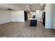 Spacious kitchen with a dark island, complemented by modern appliances and an open floor plan at 13342 W Lariat Ln, Peoria, AZ 85383