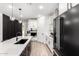 This kitchen offers white cabinets, a quartz countertop, and a stainless steel range hood at 13342 W Lariat Ln, Peoria, AZ 85383