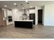 Modern kitchen featuring stainless steel appliances, a kitchen island, and white cabinetry at 13342 W Lariat Ln, Peoria, AZ 85383