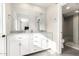 Elegant bathroom featuring dual sinks, white cabinets, and a glass-enclosed shower at 13747 W Tartan Dr, Sun City West, AZ 85375