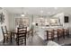 Bright eat-in kitchen featuring white cabinets, a large island with bar seating, and stainless steel appliances at 13747 W Tartan Dr, Sun City West, AZ 85375