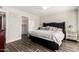 Comfortable main bedroom with a tufted headboard, closet, and wood-look flooring at 13747 W Tartan Dr, Sun City West, AZ 85375