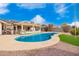 Backyard pool with patio, artificial turf, and desert landscaping for easy upkeep at 13747 W Tartan Dr, Sun City West, AZ 85375