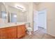 Bathroom with wood cabinet and large mirror; neutral paint, tile flooring and excellent light fixtures at 15222 N 138Th Dr, Surprise, AZ 85379