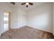 Bedroom with neutral carpet, a window with blinds, a closet, and a ceiling fan; freshly painted and move in ready at 15222 N 138Th Dr, Surprise, AZ 85379