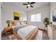 Nicely appointed bedroom with stylish decor, a modern ceiling fan, natural light, and a coordinated color palette at 15222 N 138Th Dr, Surprise, AZ 85379