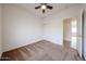 Bedroom with neutral carpet, a window with blinds, a closet, and a ceiling fan; freshly painted and move in ready at 15222 N 138Th Dr, Surprise, AZ 85379