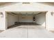 Empty two-car garage with door open; exterior address clearly displayed on the left at 15222 N 138Th Dr, Surprise, AZ 85379