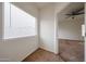 Bright hallway space with a window, connecting rooms and offering a view of the adjacent living area at 15222 N 138Th Dr, Surprise, AZ 85379