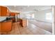 Bright kitchen seamlessly flowing into a living area, showcasing wood cabinets, stainless appliances and tile flooring at 15222 N 138Th Dr, Surprise, AZ 85379