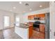 Inviting kitchen featuring wood cabinets, stainless steel appliances, a functional island, and durable tile flooring at 15222 N 138Th Dr, Surprise, AZ 85379