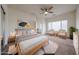 Spacious primary bedroom with a ceiling fan, neutral walls, lots of natural light, and well-coordinated furniture at 15222 N 138Th Dr, Surprise, AZ 85379