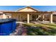 The backyard features a covered patio, a grass area, a brick walkway, and an above ground pool at 15558 N 136Th Ln, Surprise, AZ 85374