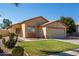 Cozy home with desert landscaping, mature trees, and a two-car garage in a quiet neighborhood at 15558 N 136Th Ln, Surprise, AZ 85374