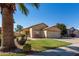 Beautiful desert-landscaped home with a two-car garage and a well-kept lawn in front yard at 15558 N 136Th Ln, Surprise, AZ 85374