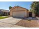 Well-kept home with a two-car garage, desert landscaping, and a cozy front yard at 15558 N 136Th Ln, Surprise, AZ 85374